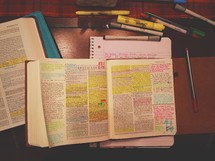 An open Bible with highlighted verses and Bible study tools.