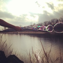 bubbles from a bubble wand over lake water