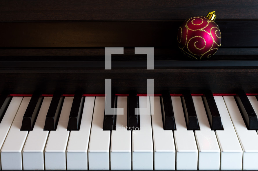 a Christmas ornament on a piano 