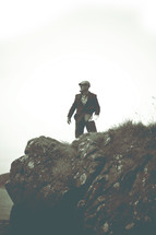 man standing near the edge of a sea cliff