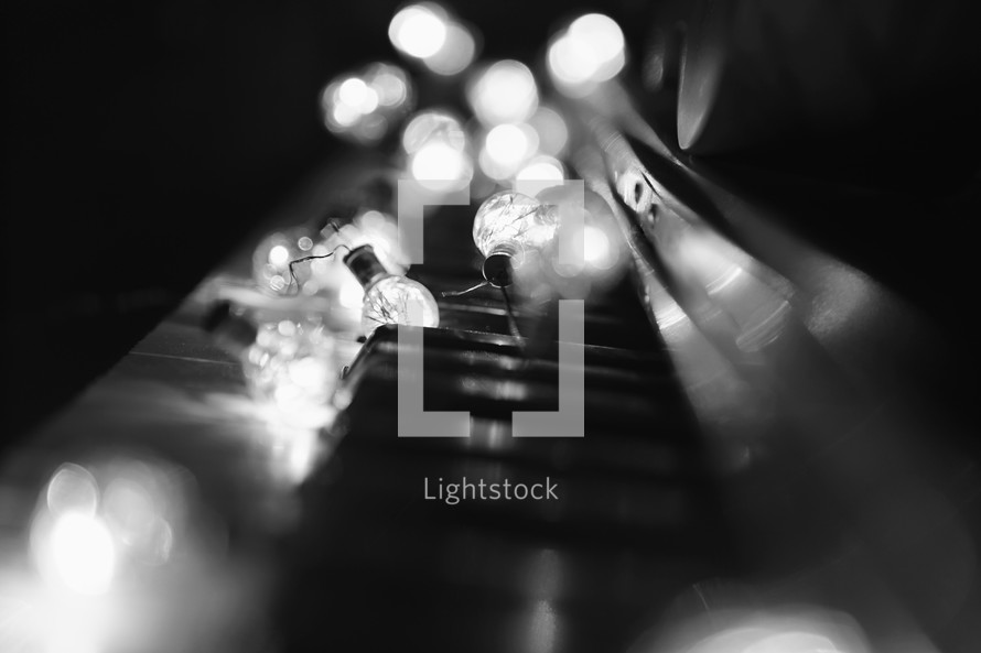lights on acoustic piano keyboard