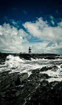 lighthouse and waves along a coast 