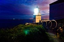 lighthouse beacon light at sunset 
