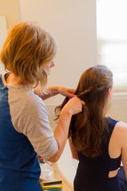 a mom braided a teen girls hair 