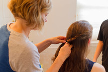 a mother braided her teen daughters hair 