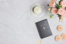 peach peonies, candle, and Holy Bible 