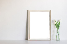 blank frame and vase with tulips 