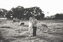 a couple standing on a farm 