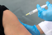 Scientist holding a syringe and vaccine vial. Global alert. Vaccination. Covid-19. Coronavirus. Research.