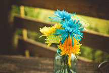 blue and yellow  flowers in a vase 