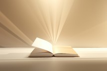 Open book with light rays on white background.
