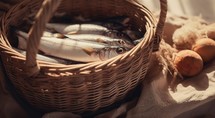 "Feeding the multitude". Fresh fishes in a wicker basket on a light background
