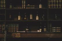 liquor and books on a bookshelf in a bar 