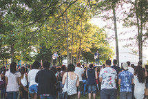 audience around a stage at an outdoors concert 