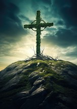 Cross with grass, on the rock, sky background. 