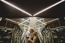 Couple holding each other  inside a building