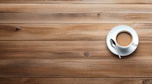 Cup of coffee on wooden table. Top view with copy space