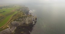 Aerial view of Etretat Aval cliff, rocks and natural arch landmark.	