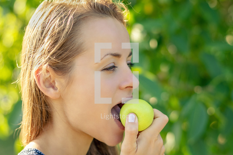 a woman eating an apple 