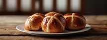 Easter. Good Friday. Homemade hot cross buns on a plate on a wooden table