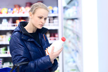 Woman in grocery holding milk