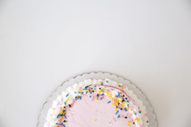 icing and sprinkles on a cake 