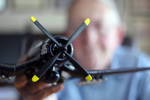 elderly man with a model airplane 