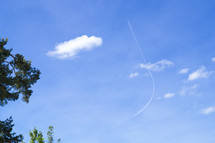 bent plane contrail in the sky 
