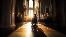 Silhouette of disabled young woman in wheelchair praying inside the church.