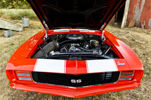 engine in a classic Chevrolet Camaro car SS Super Sport, Orange muscle car