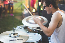 drummer playing drums at an outdoor concert