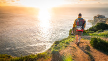 a man backpacking along the edge of sea cliffs 