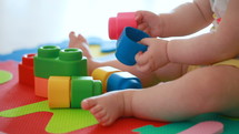 toddler playing with toy blocks 