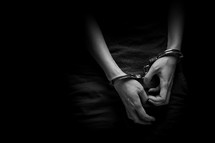 a handcuffed teen boy 