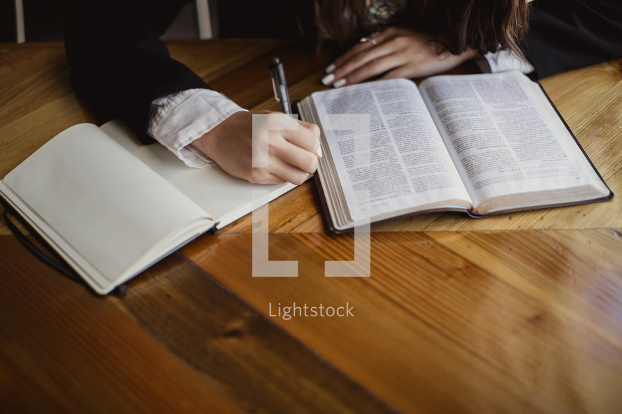 woman reading a Bible and taking notes 