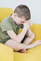 child praying with head bowed 
