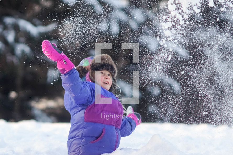 a girl playing in snow 