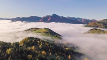 Aerial view of foggy autumn mountains landscape in alpine nature at sunrise Time lapse, Hyper lapse
