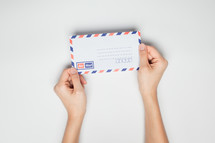 hands holding mail 
