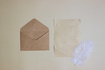 envelope, paper, and feather 