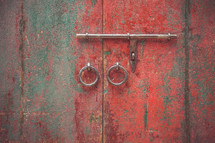 red and gray weathered doors and latches 