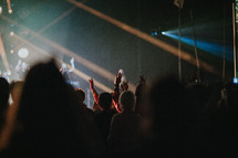 hands raised in worship at a Christian concert 