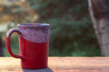 coffee mug on a railing in morning 