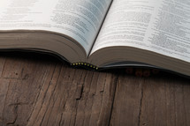 An open book on a wooden surface.