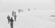 people walking on a beach in winter 