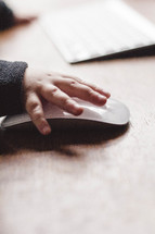 child's hand on a mouse 