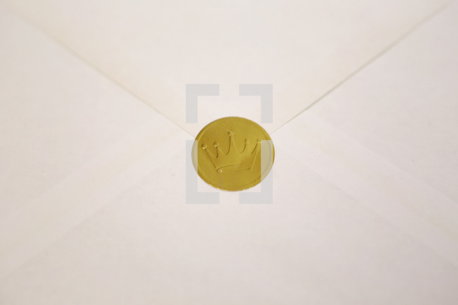 A shiny gold crown seal representing the King.