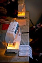Sewing machines on a table with fabric