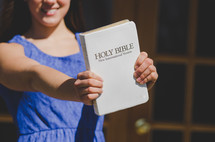 teen girl holding a Bible