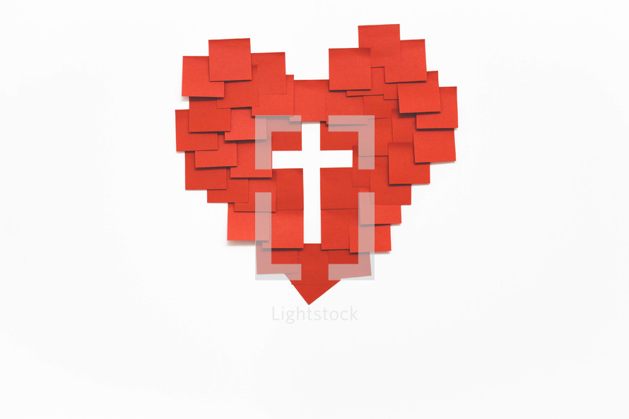 A heart made of red squares of paper with a white cross in the middle.